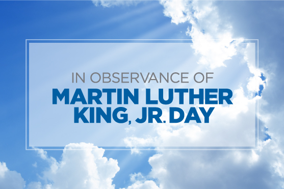 Puffy clouds against a sun-streaked daytime sky.