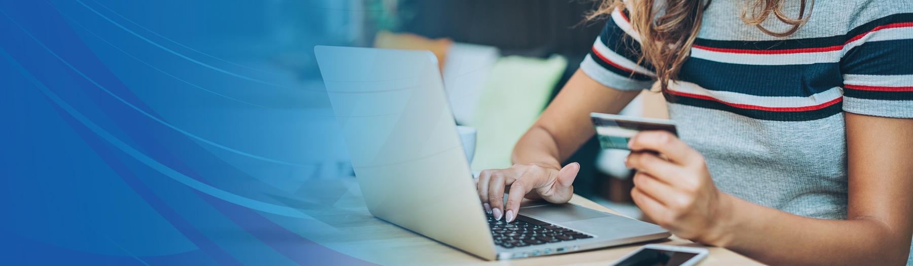 Woman entering debit card information into computer