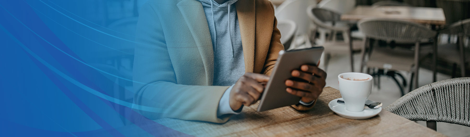 Businessman working on his tablet in a coffee shop