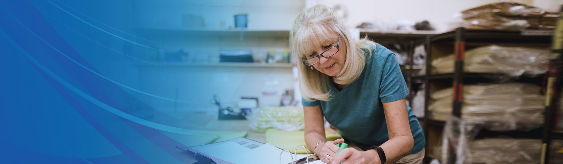 Mature female business owner working on finances in her retail store