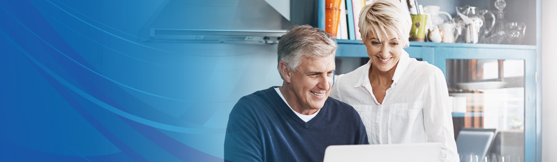 Man and woman in their home looking at a computer screen