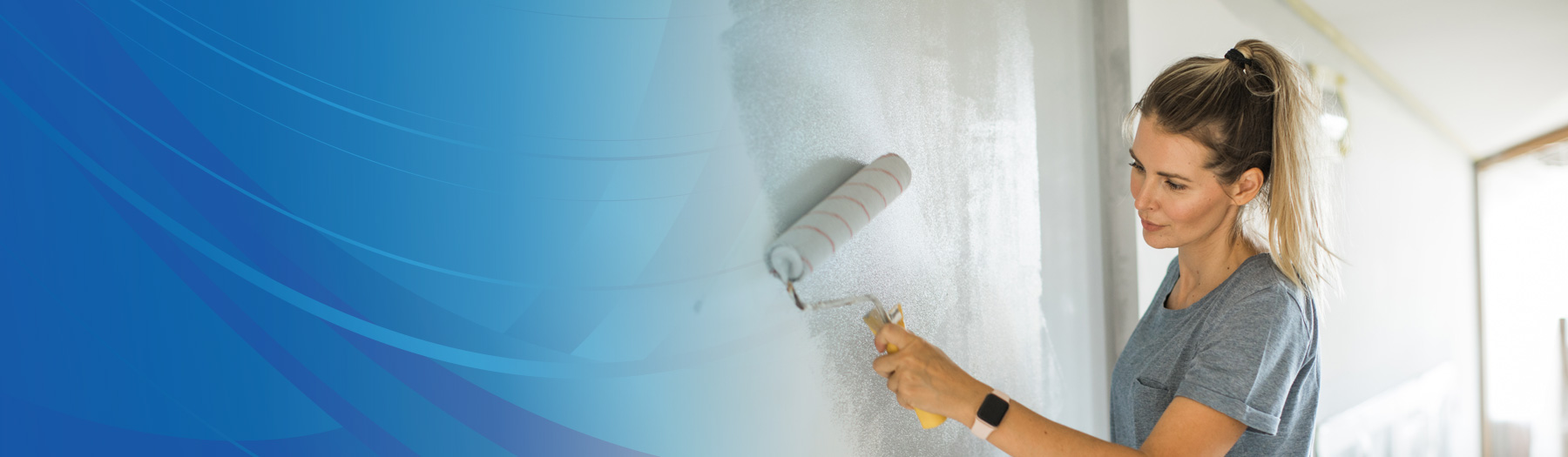 Woman painting wall with a paint roller