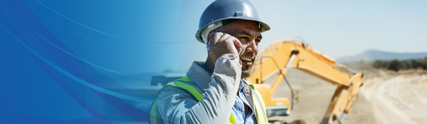 Business owner talking on his mobile phone at a construction site