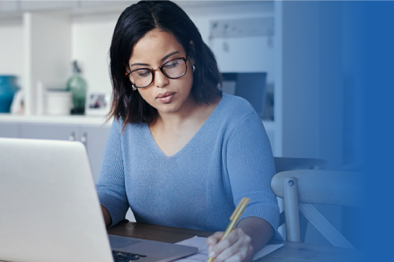 Young Hispanic woman working on a laptop from her home