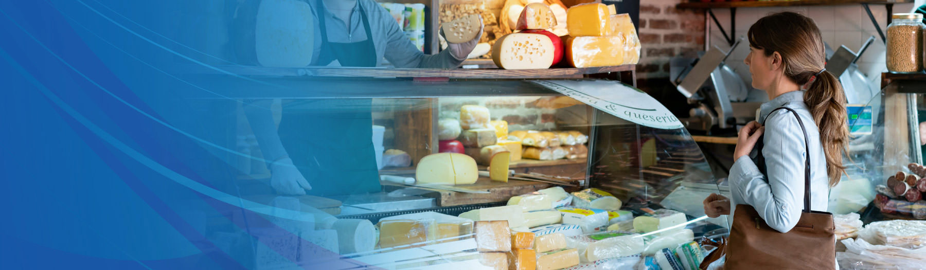 A woman ordering food at a deli counter