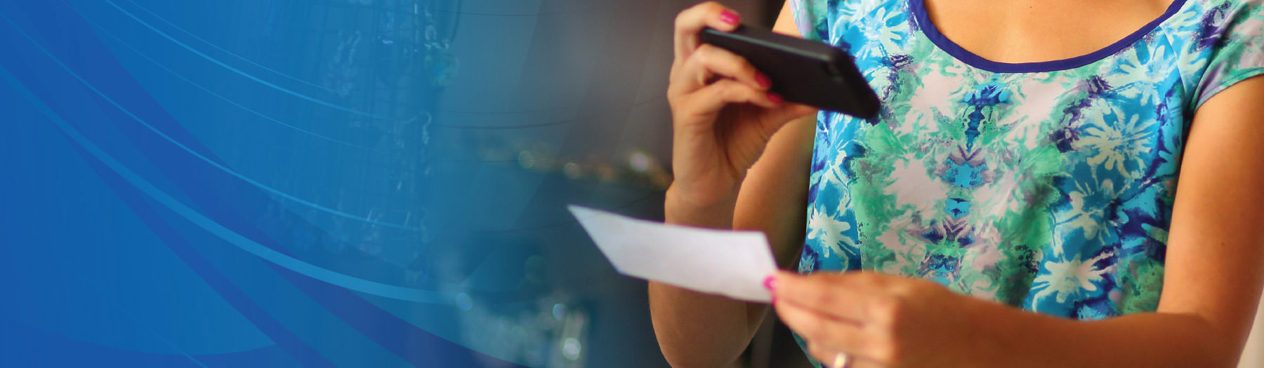 A woman taking a picture of a check with a smartphone